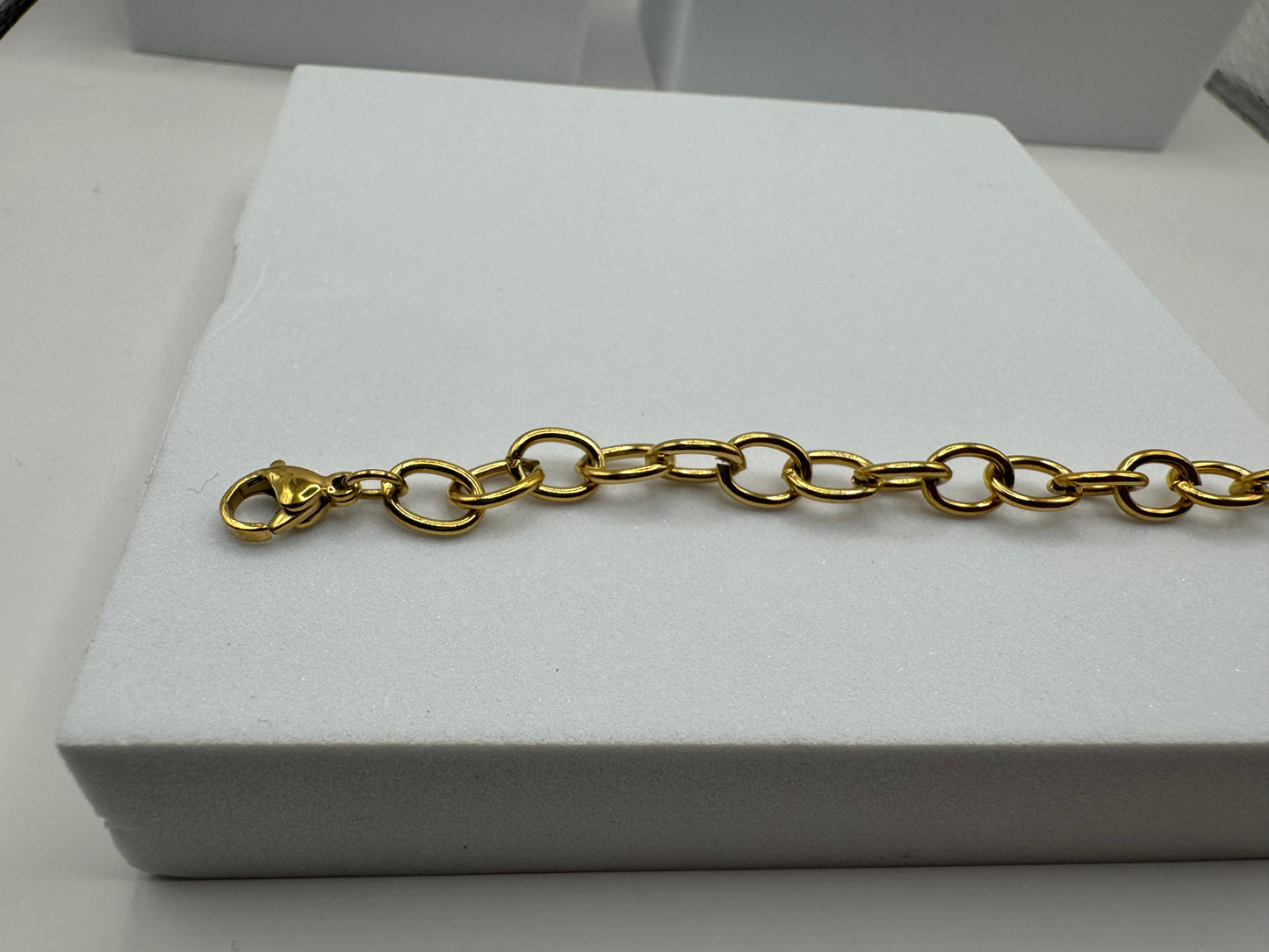 The Rowan Bracelet displayed flat, highlighting adjustable chain links and modern design.