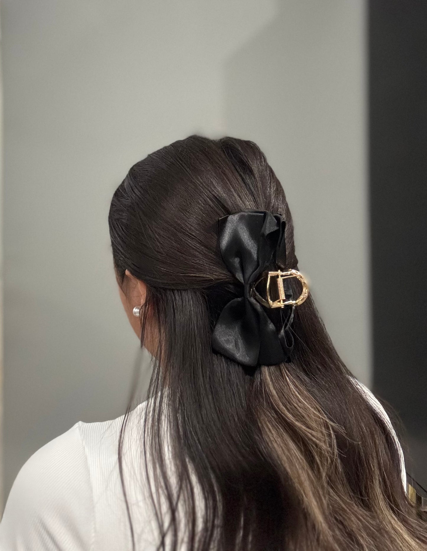 Model wearing EMPIECE™ Paloma Hair Clip in black satin bow, luxe accessory in hair.