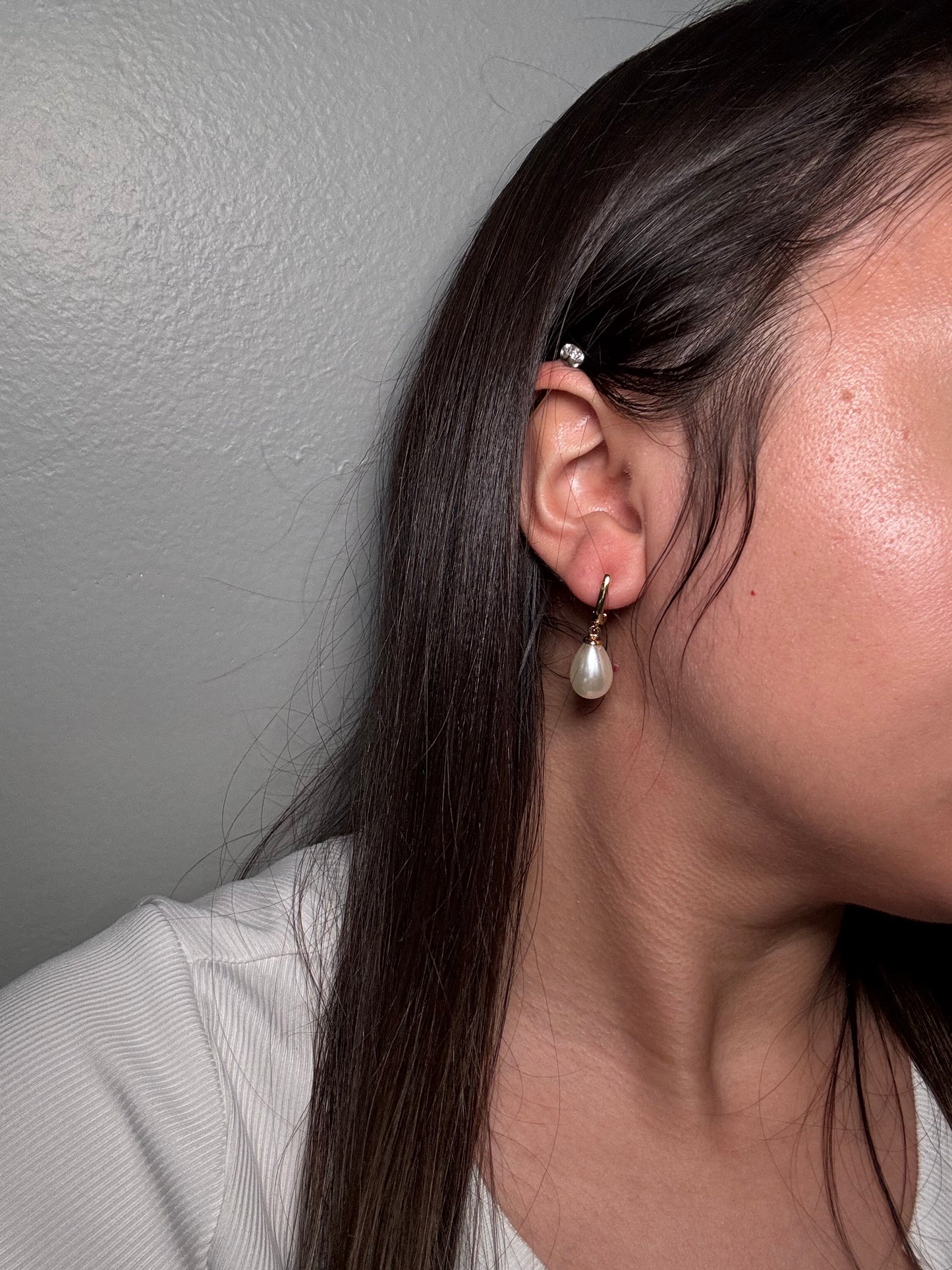 Model wearing The Amara Earrings, showcasing pearl drop detail and elegant gold hoop.