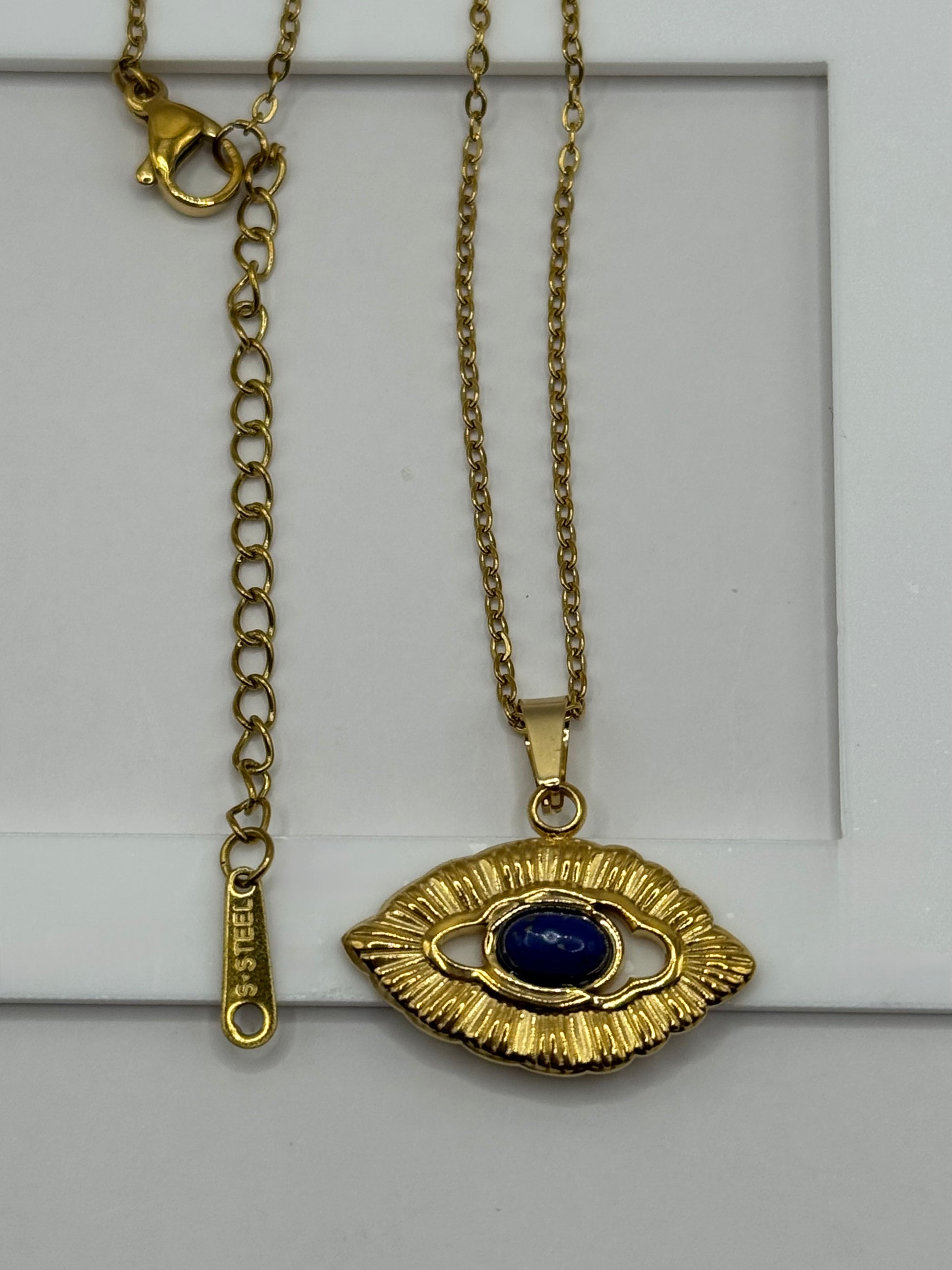 DDetailed shot of Orovie necklace and earrings ogether, highlighting gold and cobalt accents.