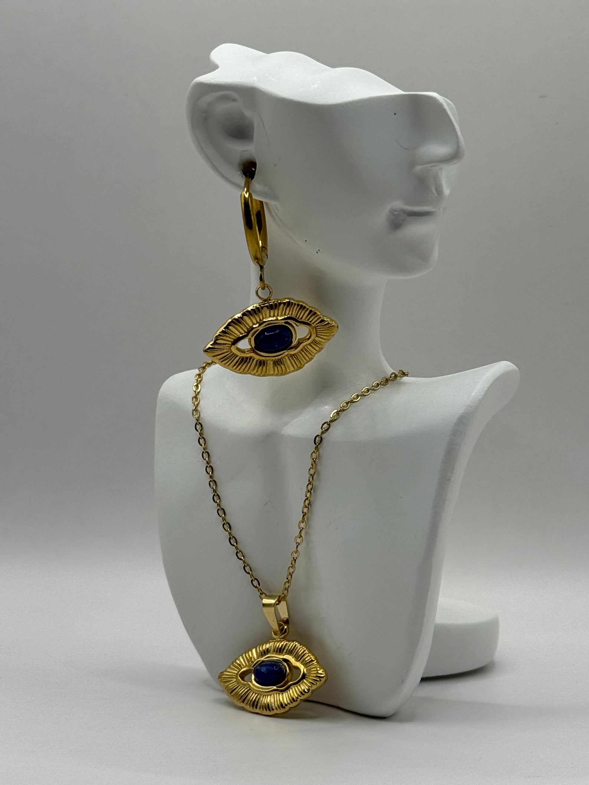 Orovie necklace displayed on white bust stand, showcasing gold frame and cobalt eye pendant.