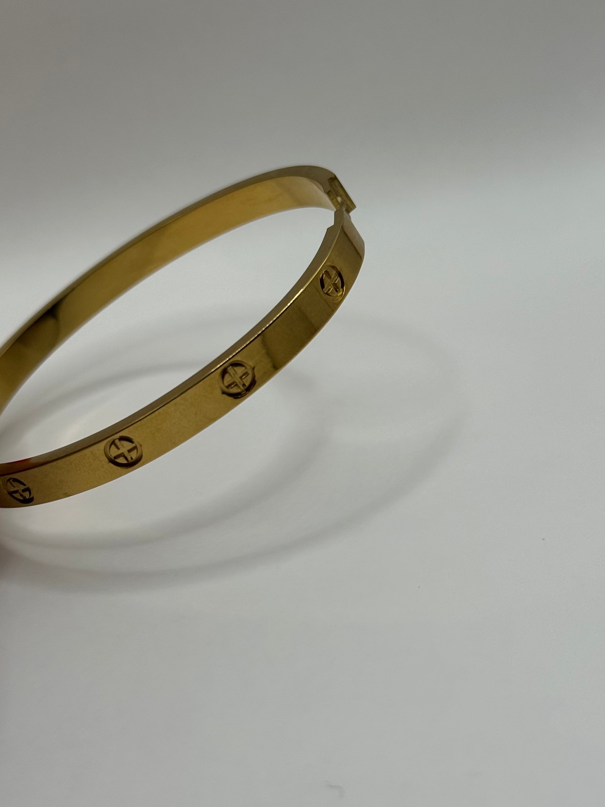 Side view of The Eterna Bracelet highlighting slim round silhouette and subtle engravings.