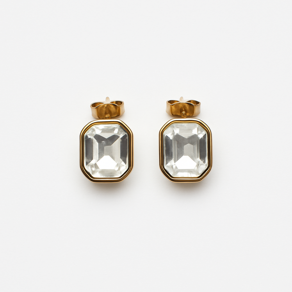 Gold-plated stainless steel studs with clear faceted glass inlay shown against a white background.