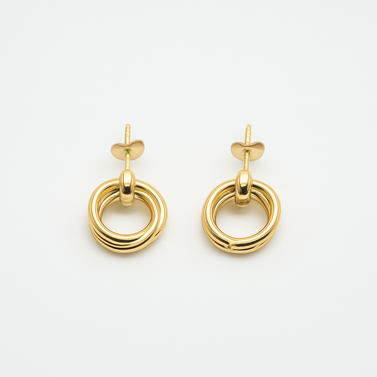 The Entwined Earrings close-up of gold double-ring stud design on white background.
