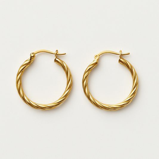 Front view of The Cinta Twist gold hoop earrings by EMPIECE™, featuring elegant interlacing curves in a polished gold-tone finish.