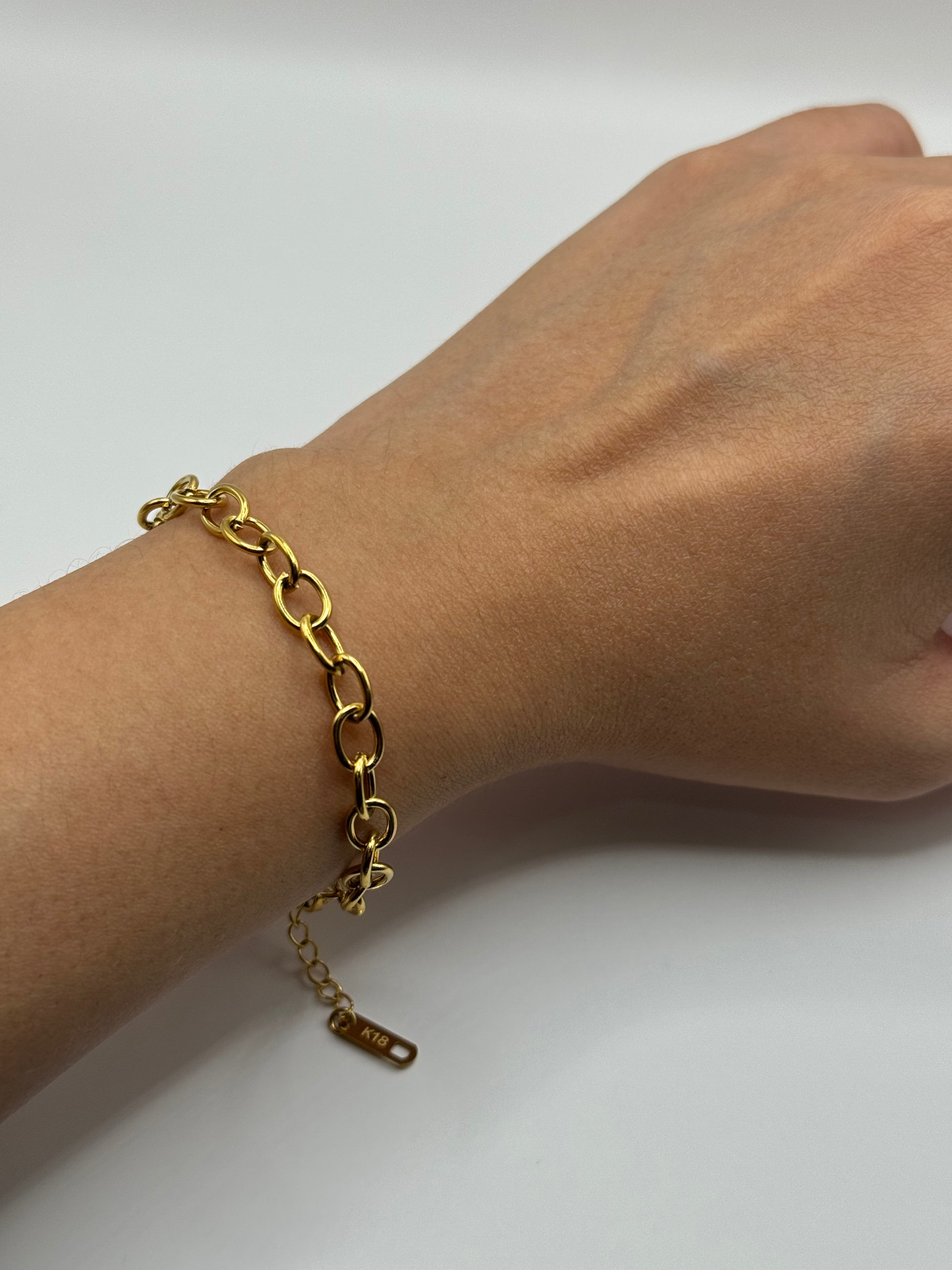 The Rowan Bracelet styled on wrist, minimalist gold chain design for versatile everyday wear.