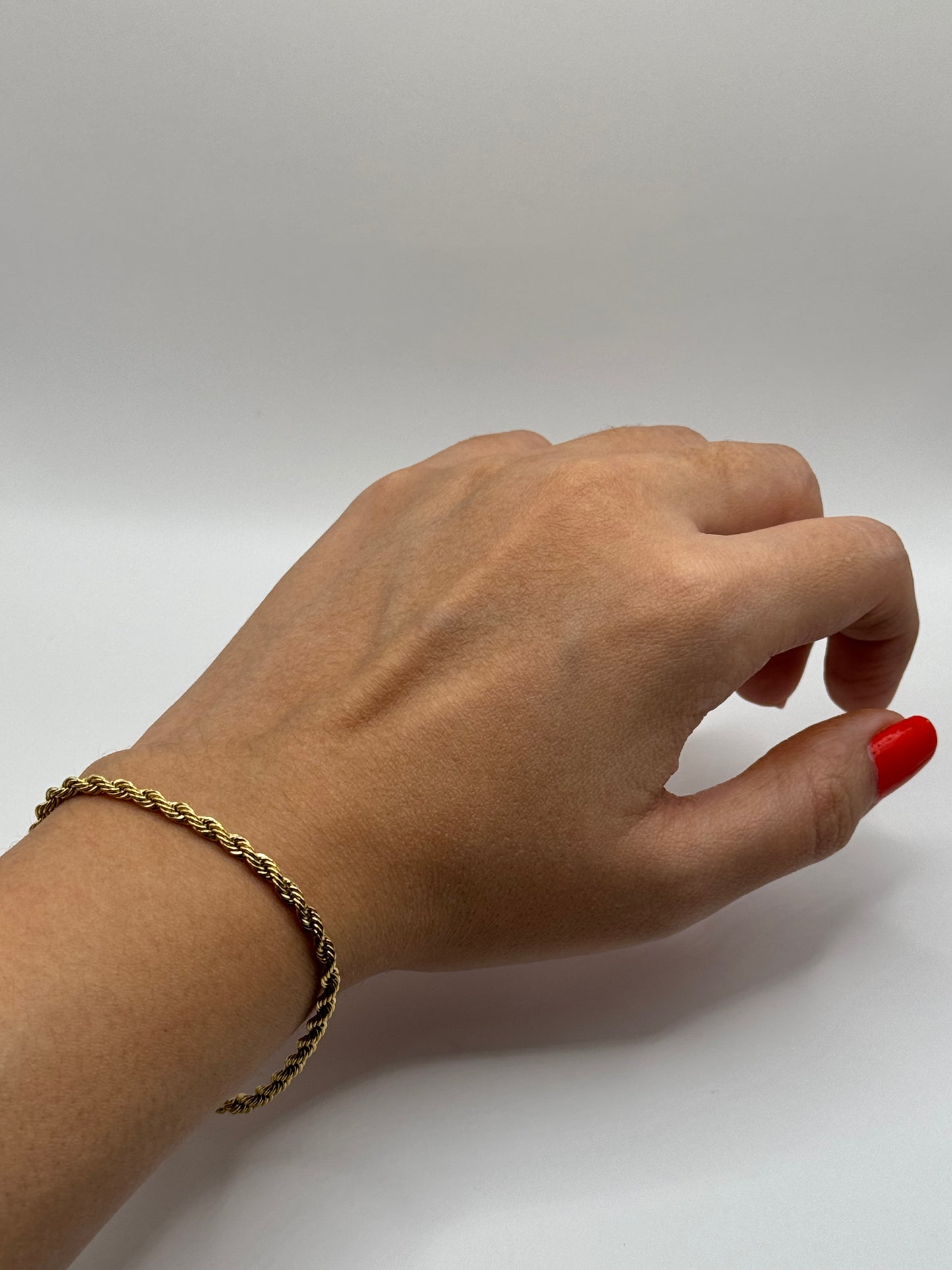 Model wearing The Livara Bracelet, showcasing its sleek, versatile gold rope chain design.