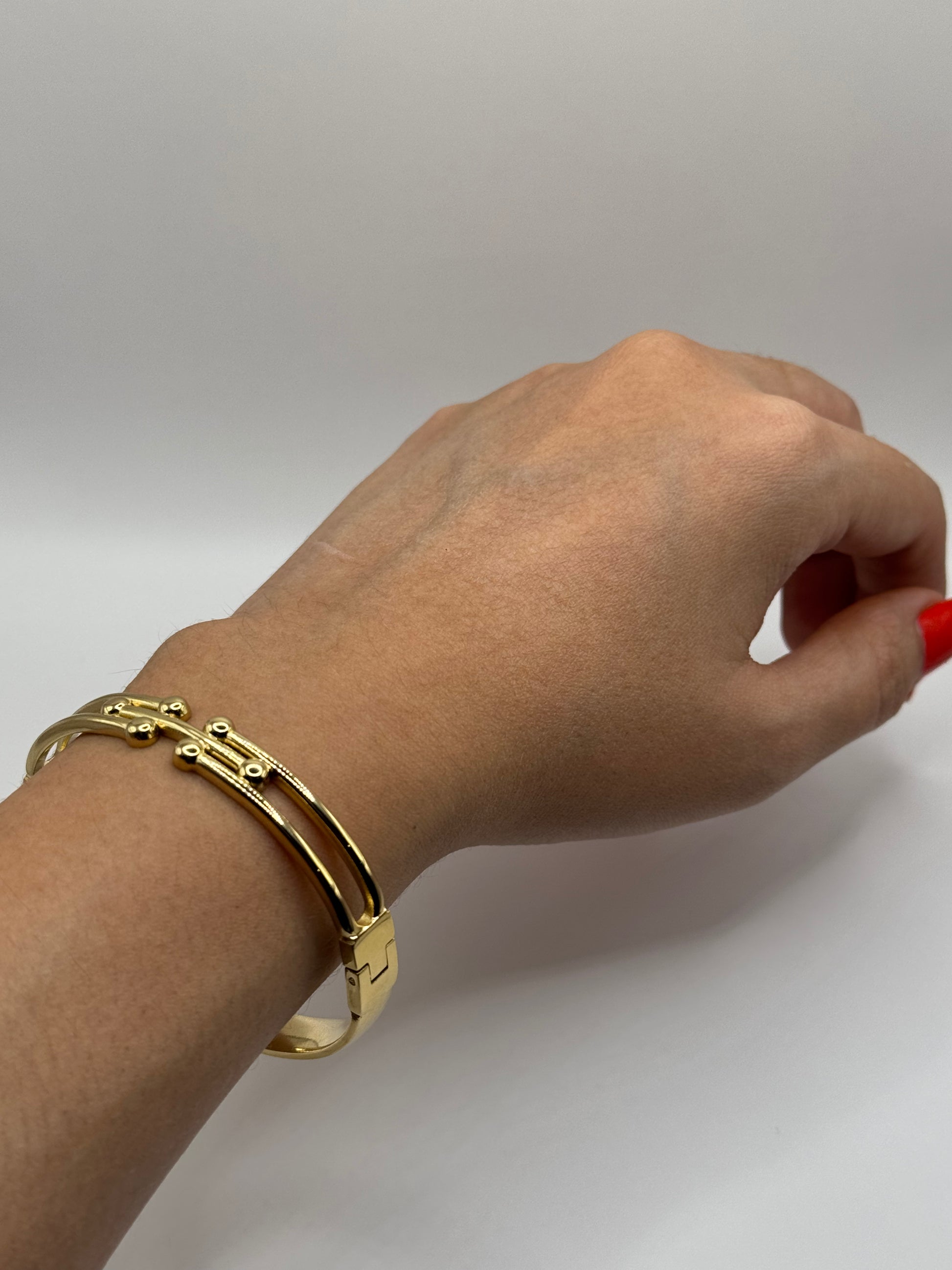 The Colette Bracelet worn on a wrist, styled as an everyday accessory with a refined gold finish.