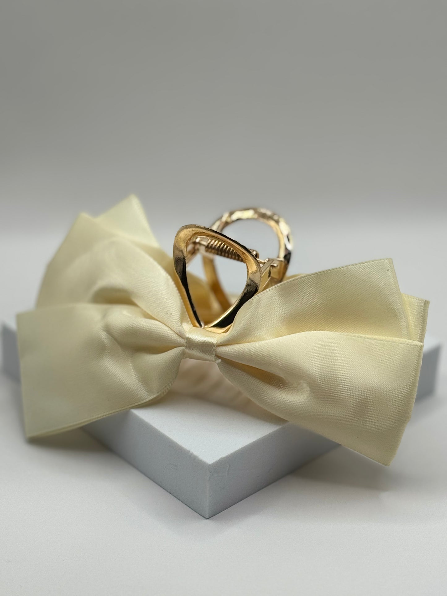 Ivory EMPIECE™ Paloma Hair Clip with satin bow and gold claw, elegant soft luxe style.