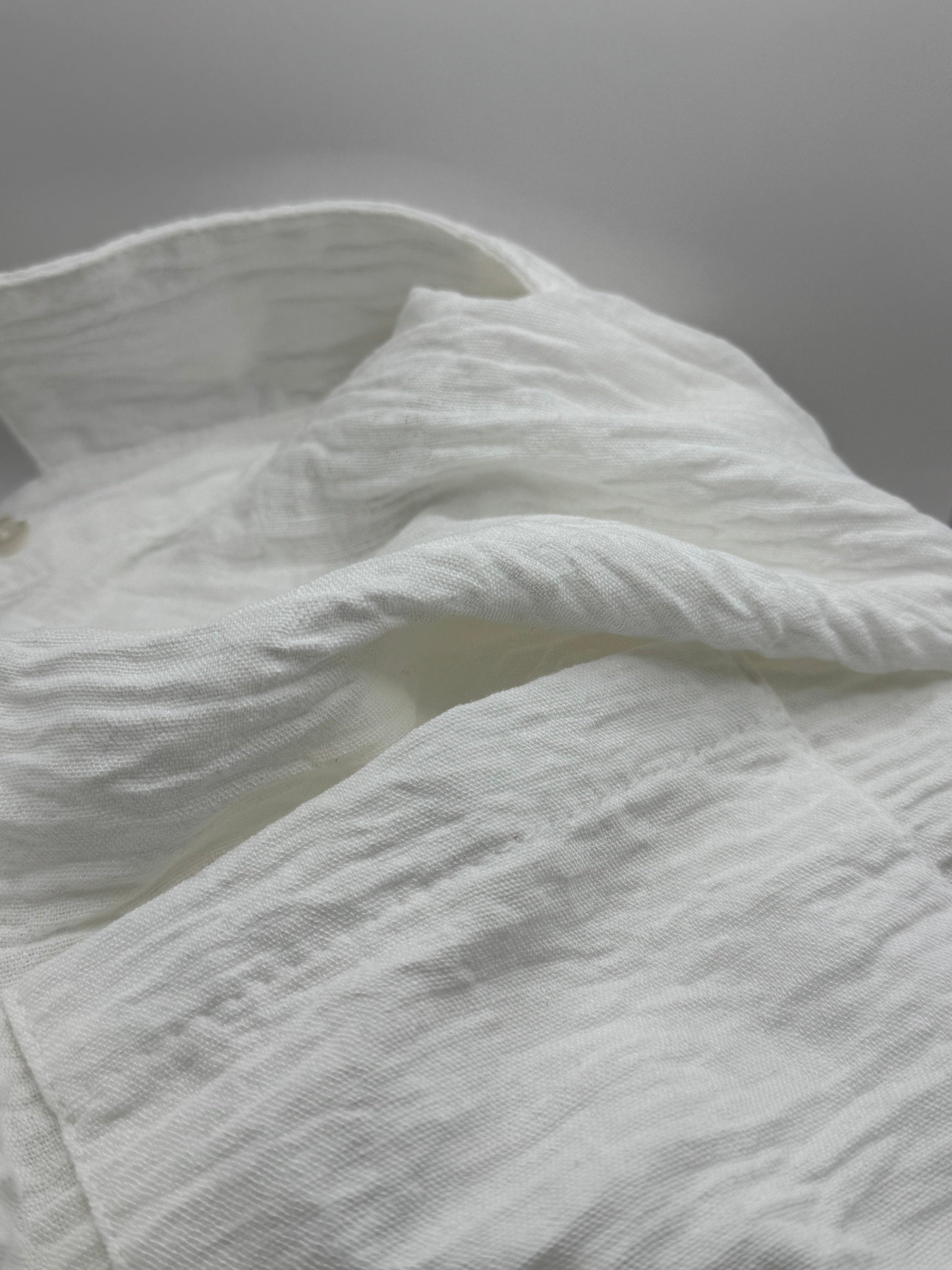 Close-up of the soft viscose-linen blend fabric of The Clarity Whisper Top, showing its natural drape and airy texture.