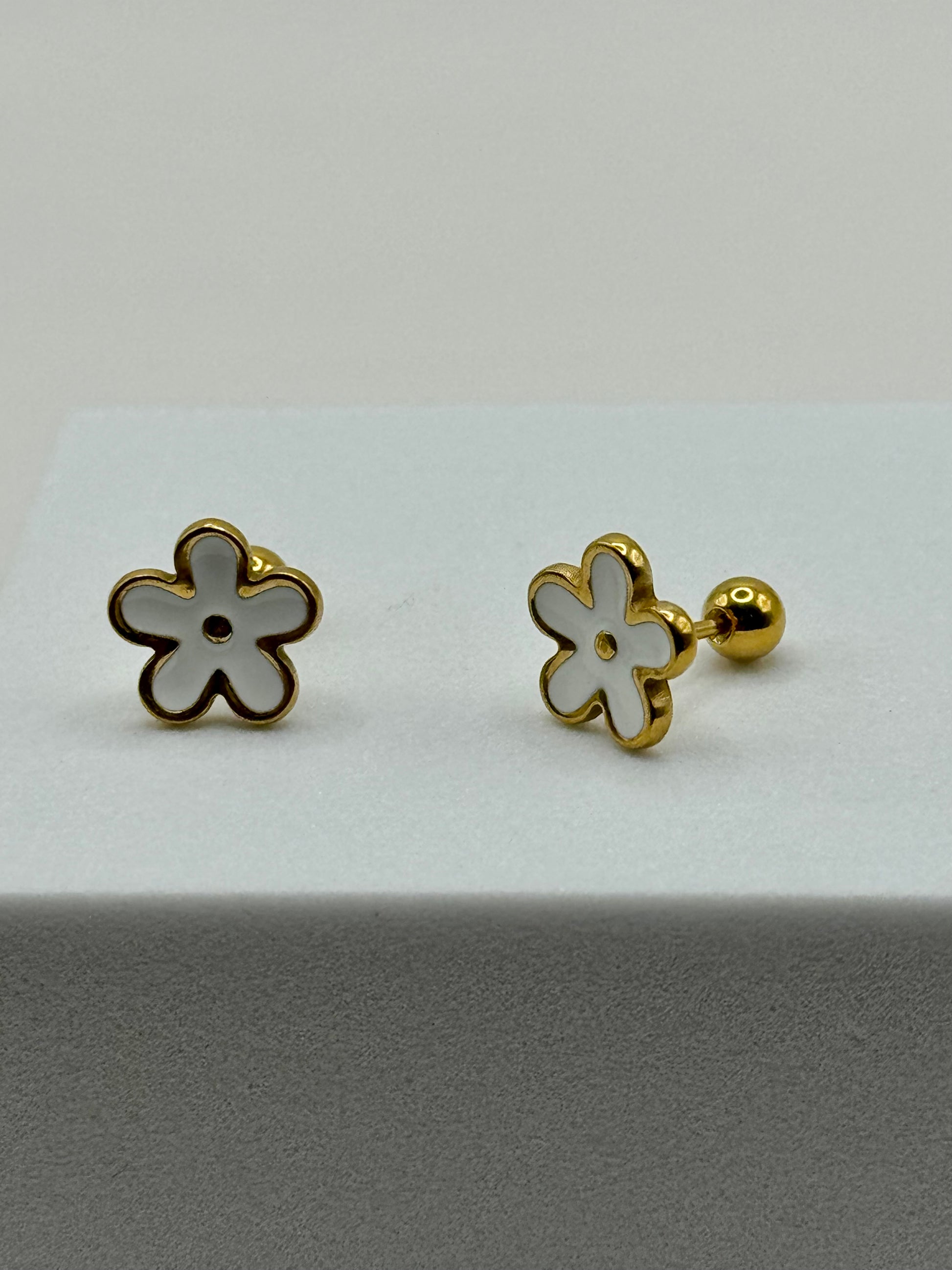 The Gardenia Earrings front view on white surface showcasing flower-shaped enamel design.