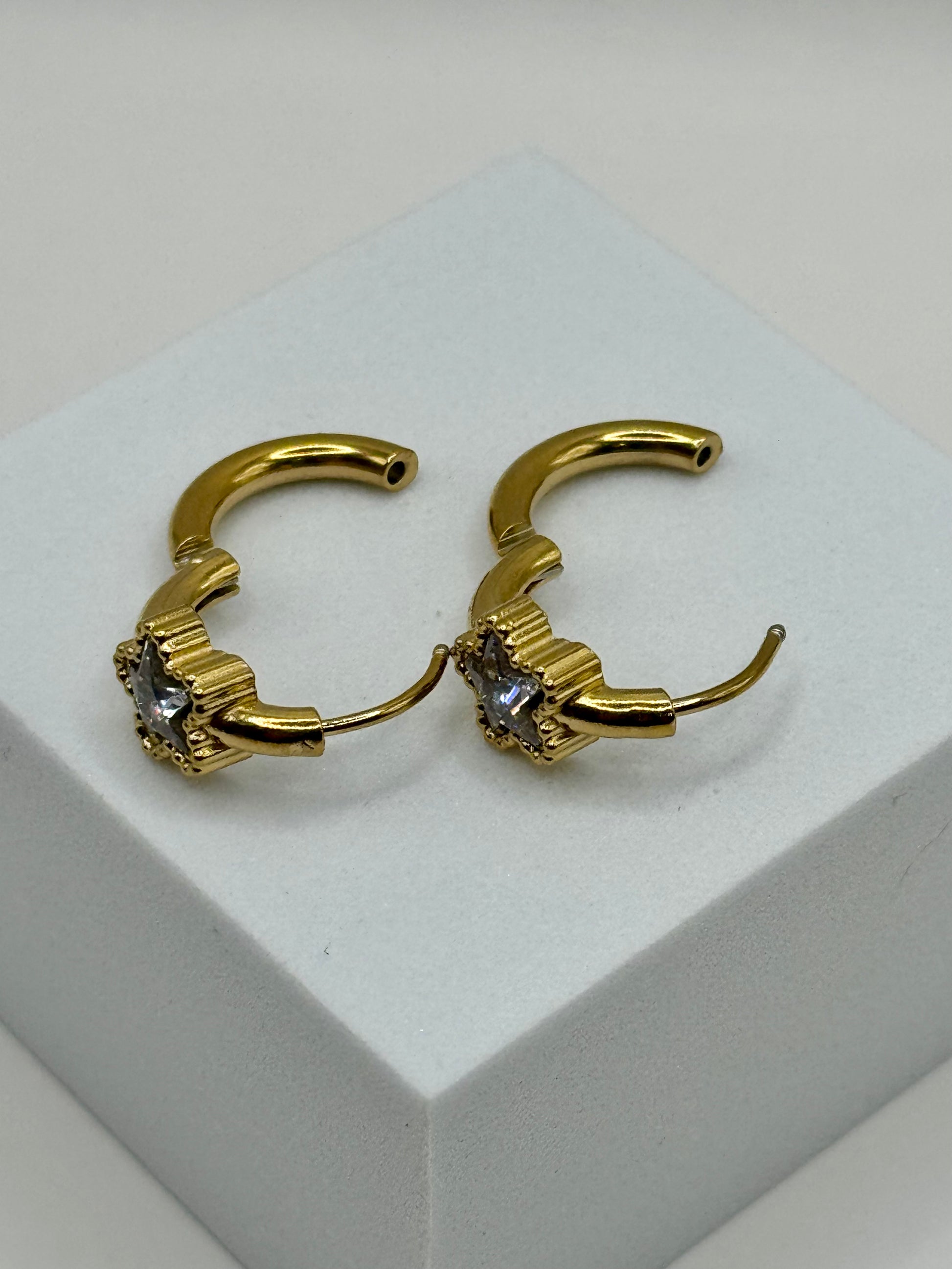 The Azure Hoops side view showing latch-back closure and silvery gray-blue star detail on display stand.