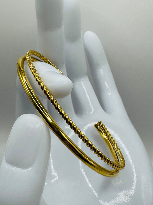 Gold Orion Bracelet displayed on a mannequin hand, showing ridged detailing and open-ended design.