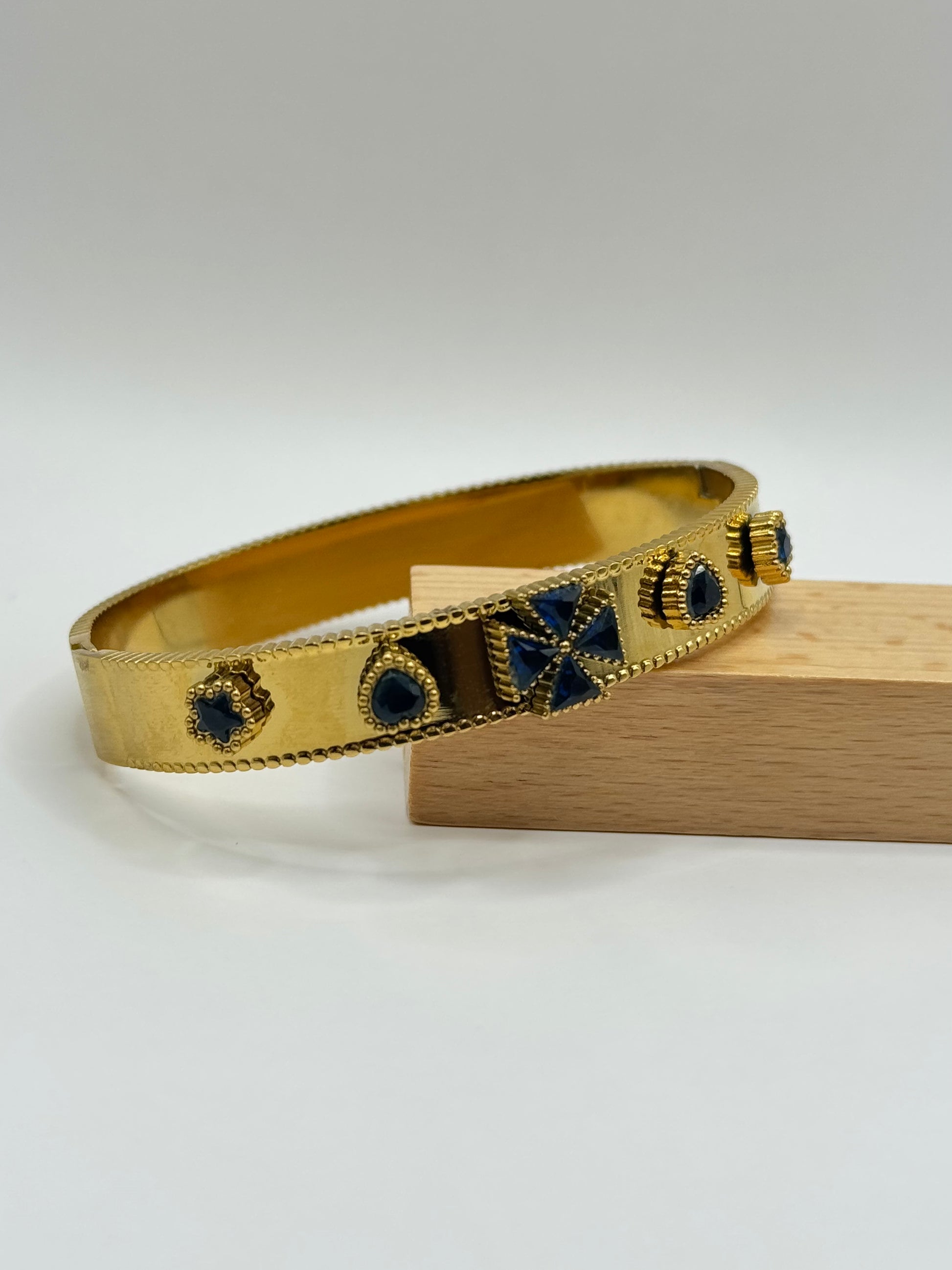 The Noctara Bracelet displayed on stand highlighting celestial motifs and cobalt inlays.
