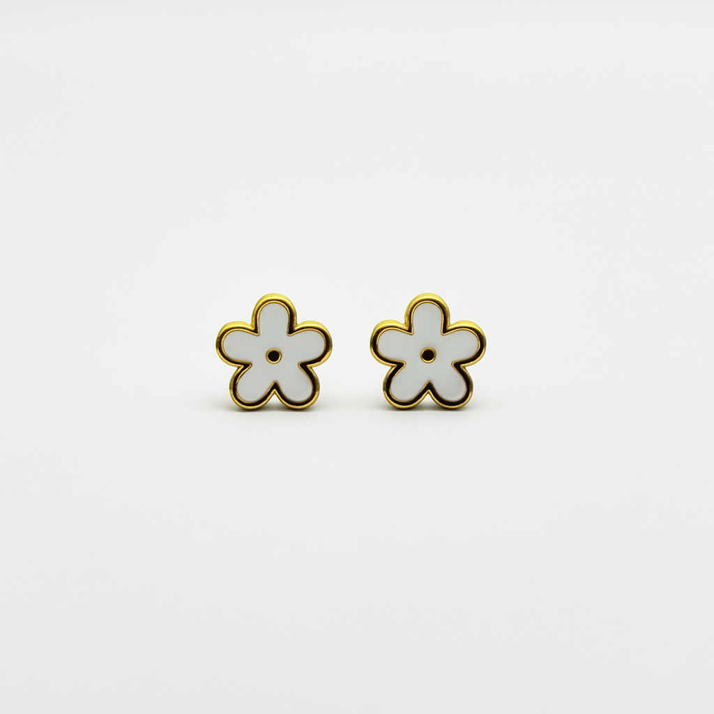 The Gardenia Earrings gold and white enamel flower studs close-up on white background.
