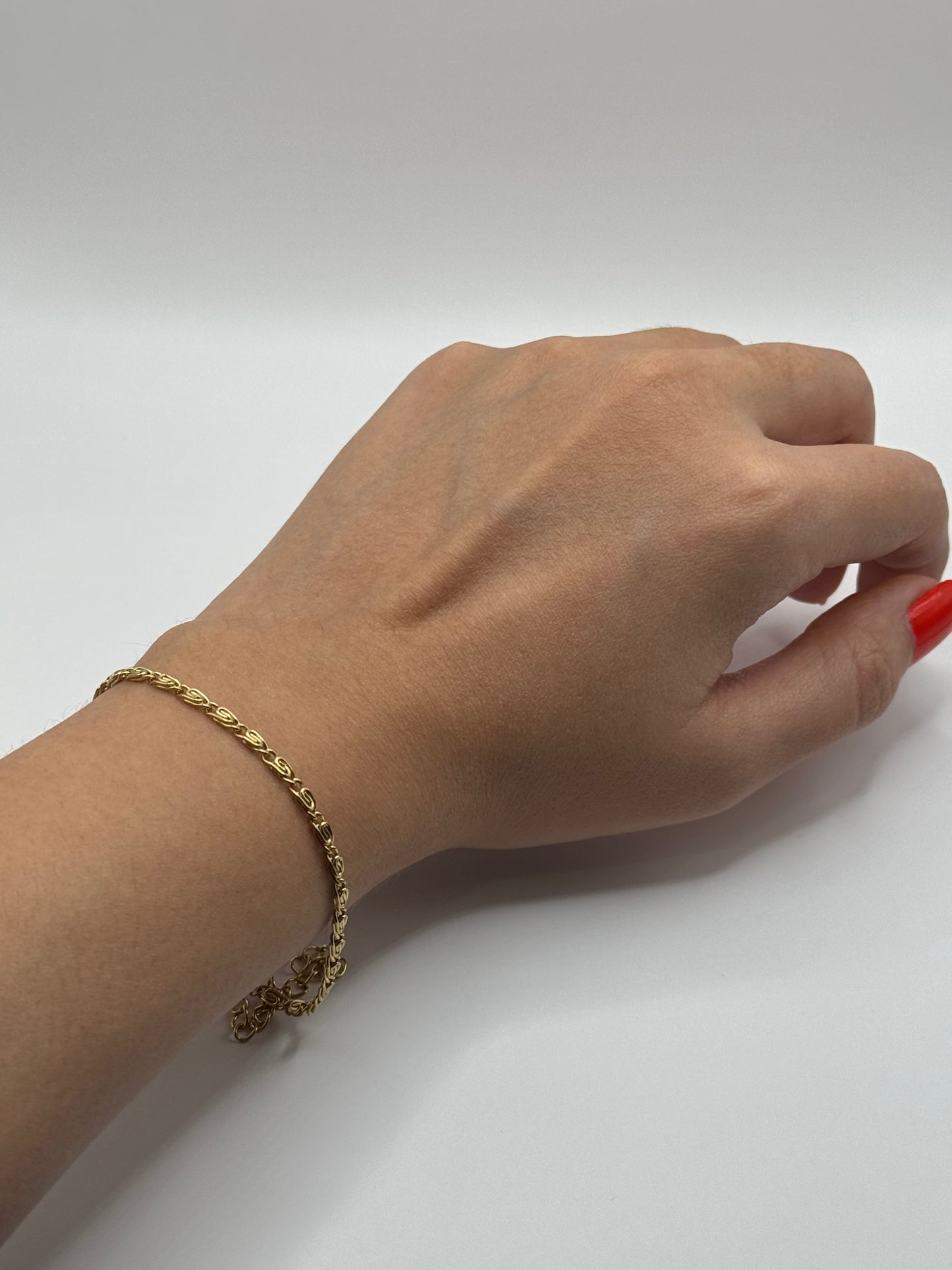 Amélie Bracelet styled on wrist, lightweight gold-tone chain for everyday elegance.