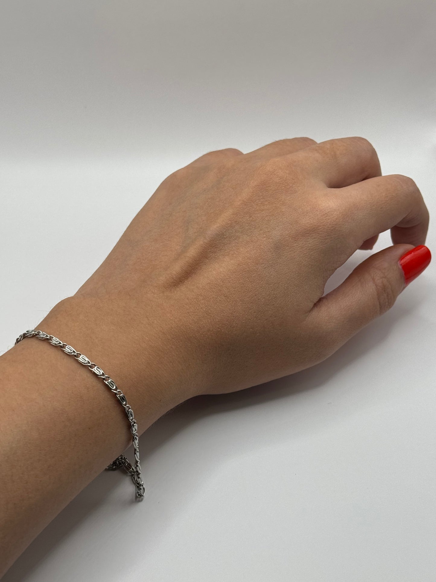 Elise Bracelet worn on wrist- silver-tone stainless steel chain bracelet styled for everyday minimalism, highlighting its versatile design.