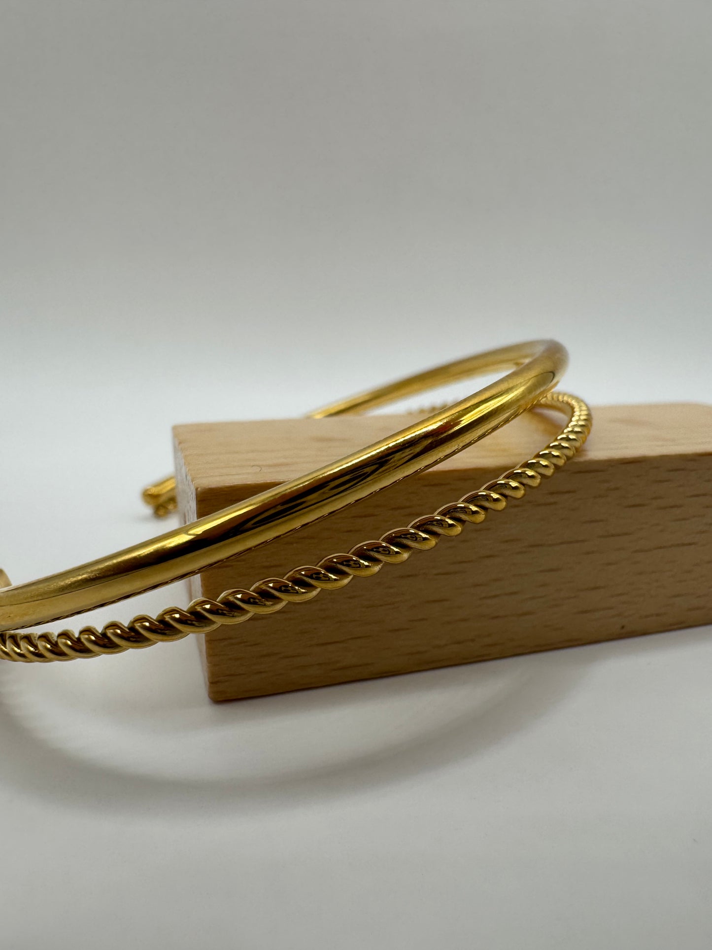 Side view of the Orion Bracelet, highlighting its slim silhouette and polished gold finish.