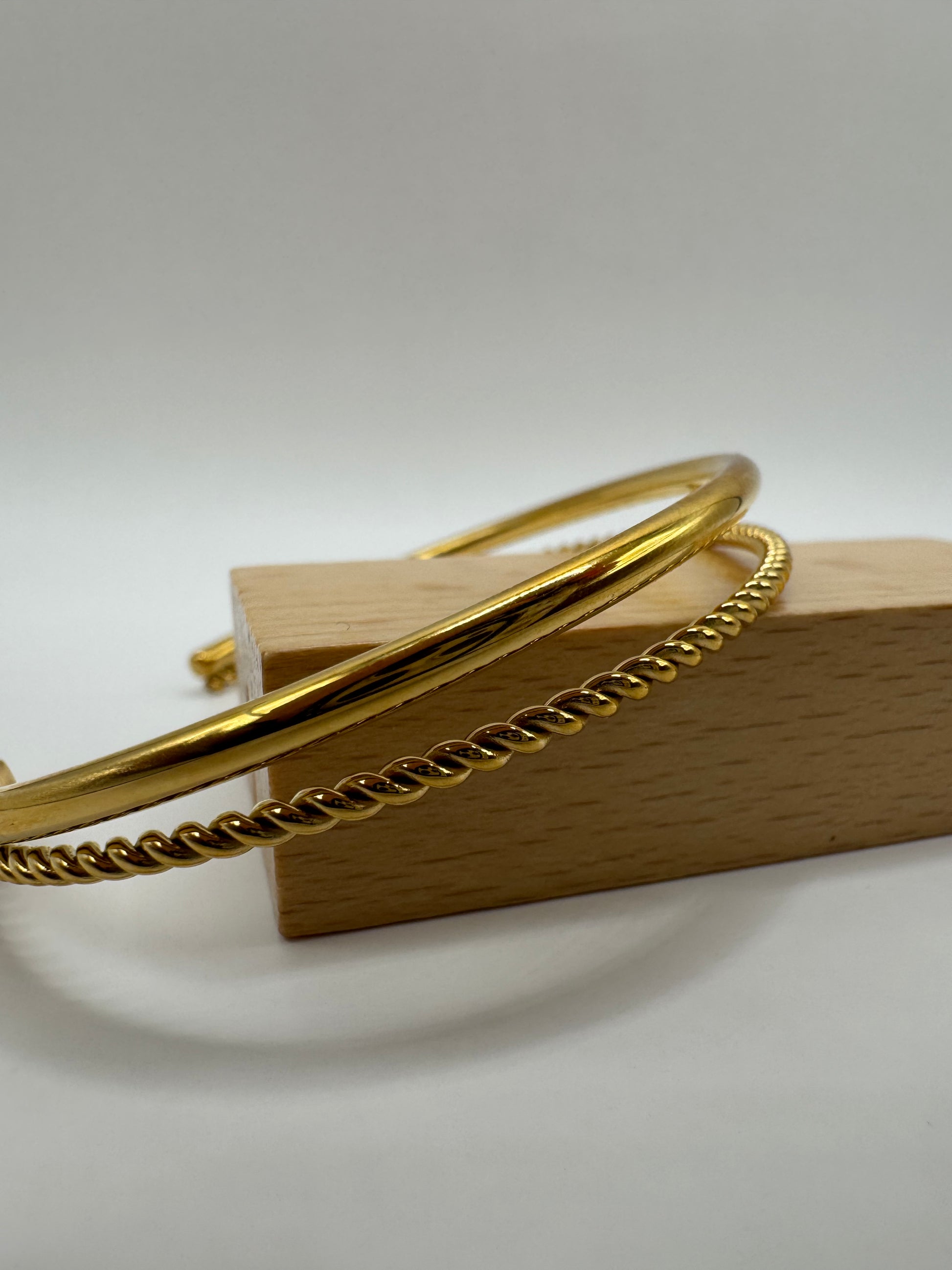 Side view of the Orion Bracelet, highlighting its slim silhouette and polished gold finish.