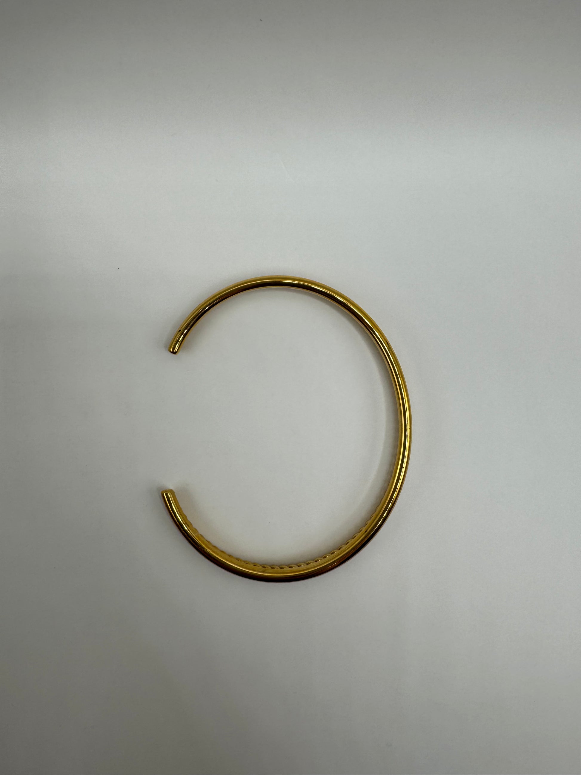 Overhead view of the Orion Bracelet, showcasing its circular open-ended shape.