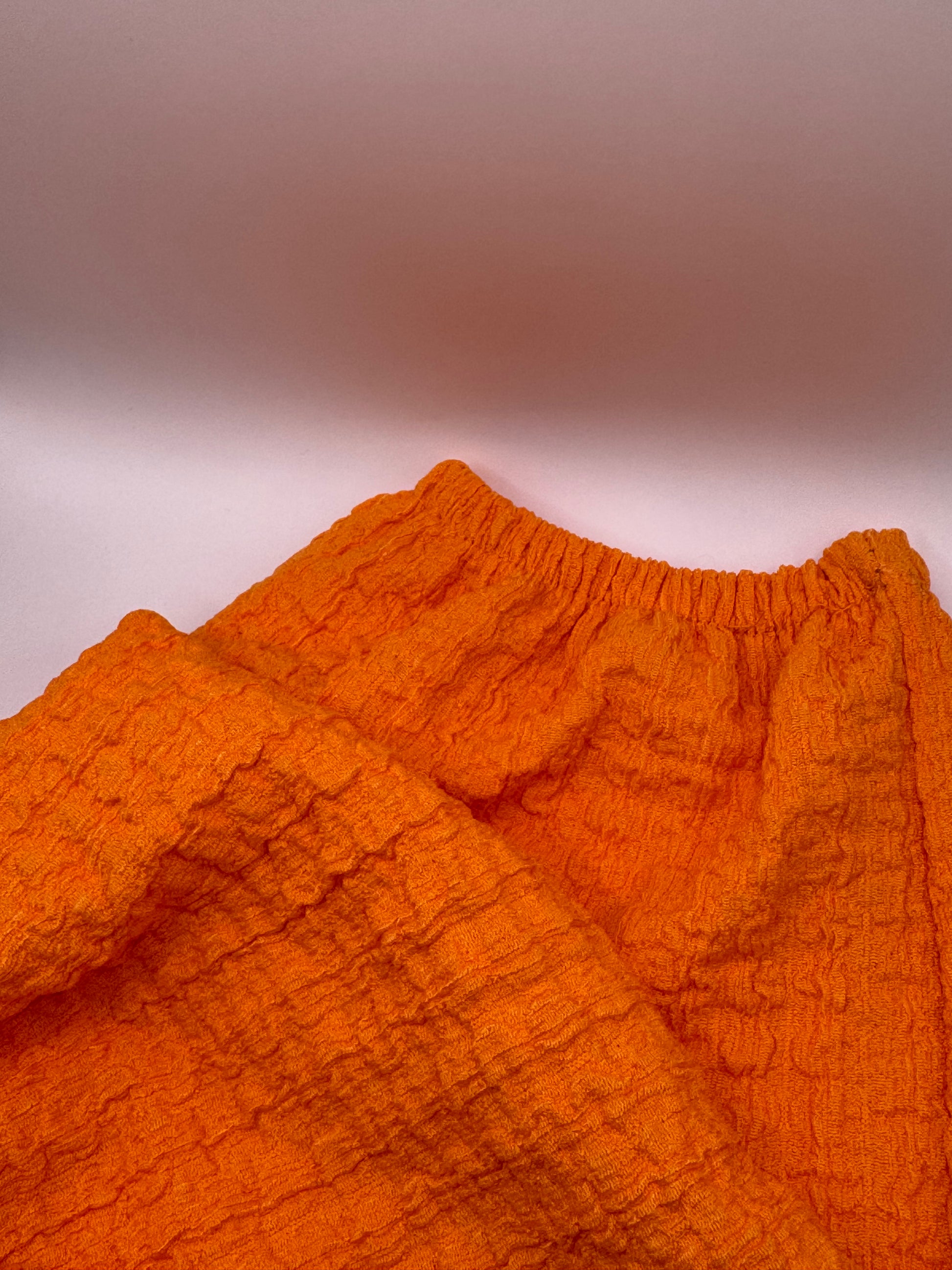 Close-up of The Scarlet Allure Top’s elastic cuff, highlighting the softly gathered long sleeve design.