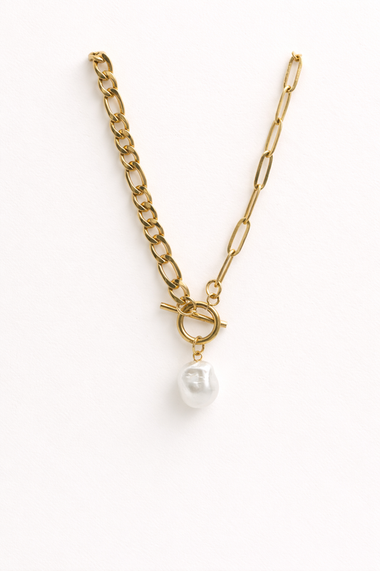 The Perla Necklace by EMPIECE™ — gold paperclip chain necklace with a single pearl pendant on a soft white background.