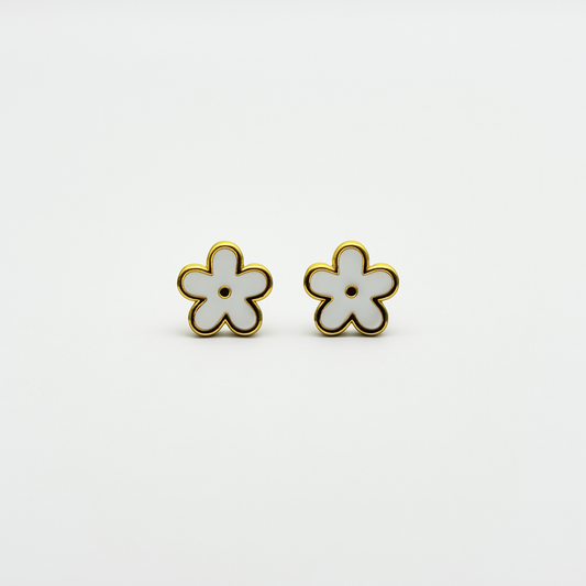 The Gardenia Earrings gold and white enamel flower studs close-up on white background.