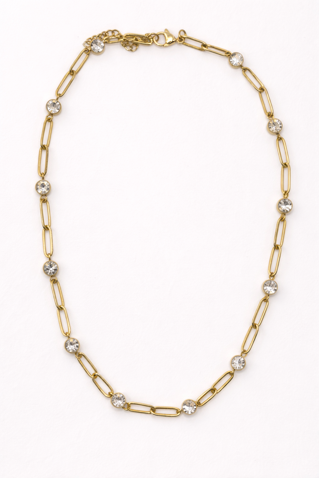 EMPIECE™ The Adelaide Necklace in gold, featuring a paperclip chain with crystal accents on a soft white background.