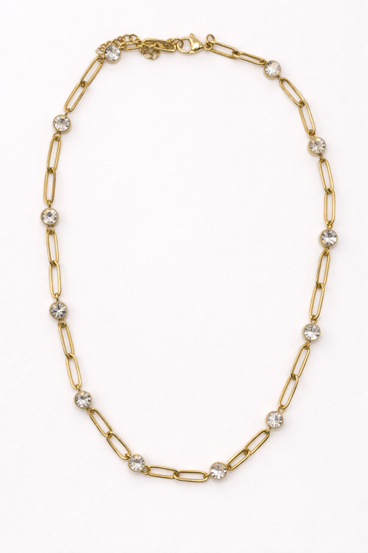 EMPIECE™ The Adelaide Necklace in gold, featuring a paperclip chain with crystal accents on a soft white background.