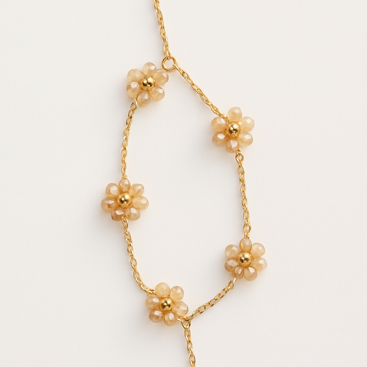 Gold floral link bracelet with pink bead accents on white background, The Fleurette Bracelet by EMPIECE™