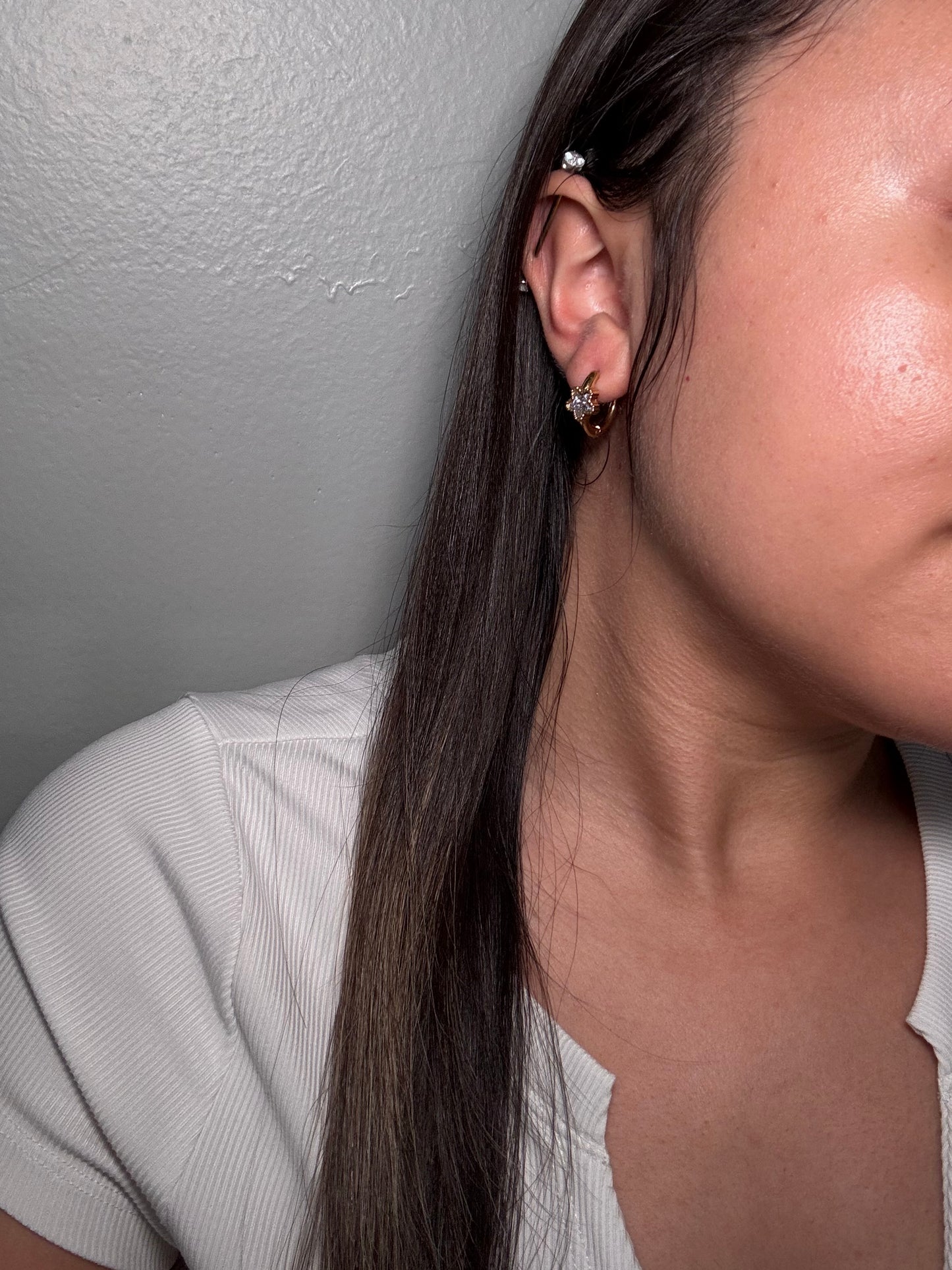 Gold hoop earrings with purple star-cut stones worn on ear, The Petite Orbit by EMPIECE™
