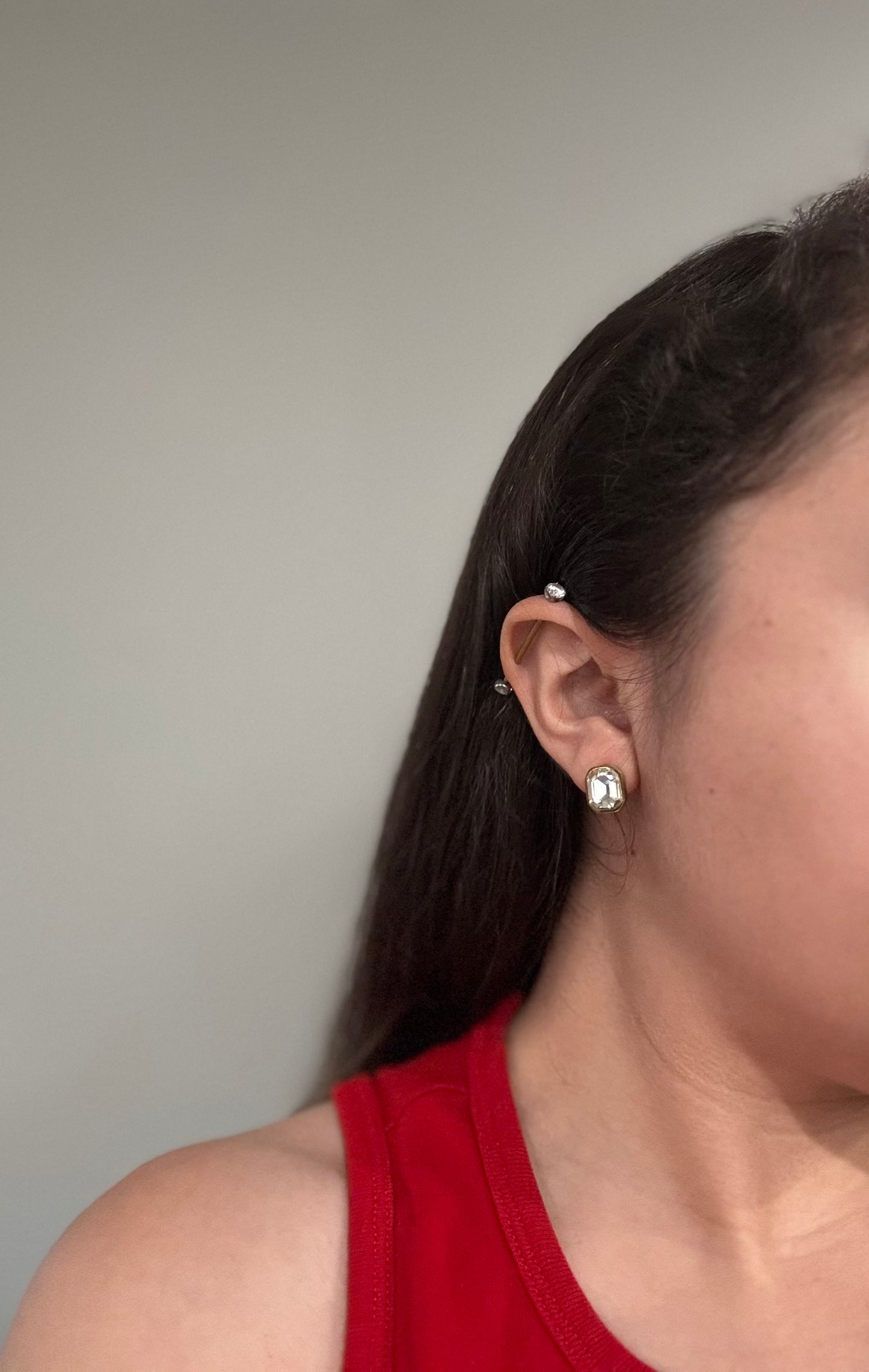 Gold stud earrings with faceted glass inlays worn on ear, The Soleil Earrings by EMPIECE™