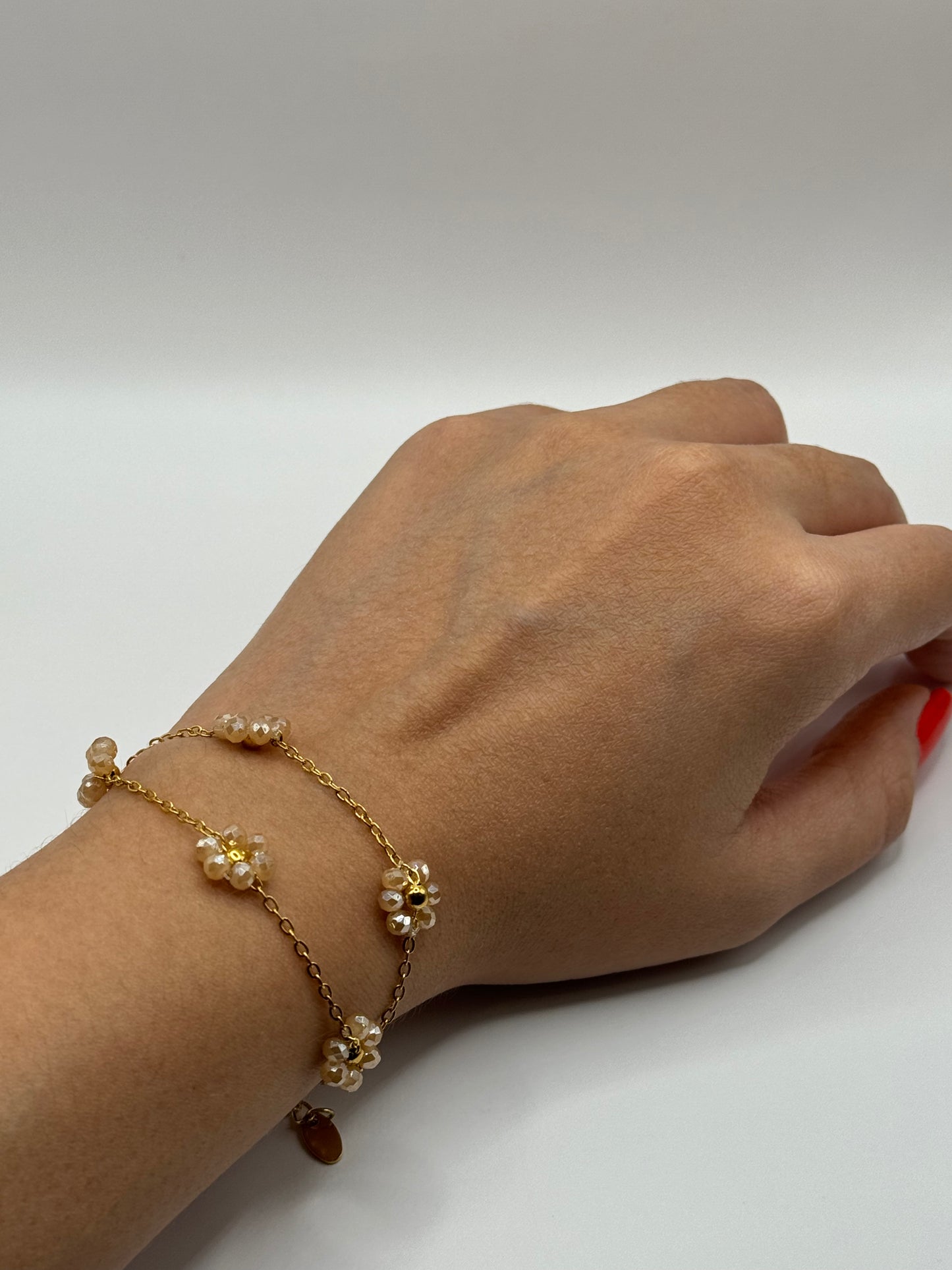 Pink floral chain bracelet worn on wrist with adjustable gold clasp, The Fleurette Bracelet by EMPIECE™